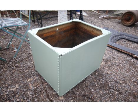 A green painted galvanised water tank/planter