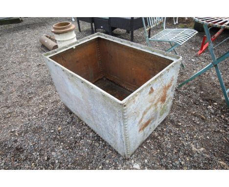 A large galvanised riveted water tank/planter