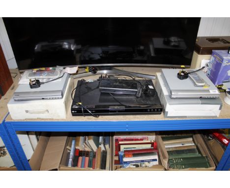 Two Alba DVD players with remote controls; an LG DVD recorder etc.