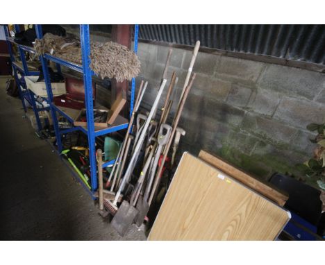 A quantity of gardening tools including digging fork, spade, sledgehammer, brooms etc