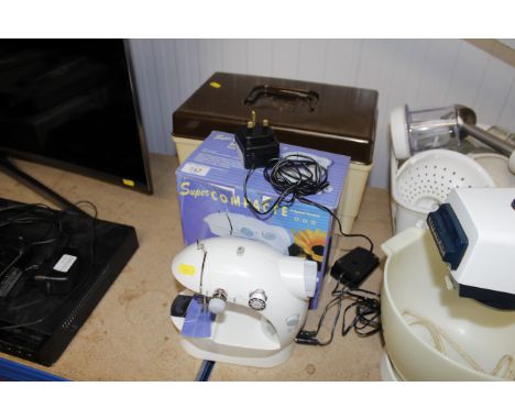 A Super Compact sewing machine and a sewing box with contents