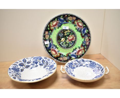 Two Charlotte Rhead for Bursley Ware pottery floral carnation pattern bowls, decorated in shallow relief in blue slip and emb