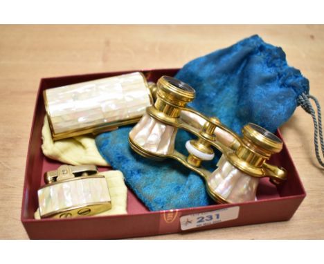 A pair of 20th century brass opera glasses having folding handle with mother of pearl inlay, sold together with a cigarette c