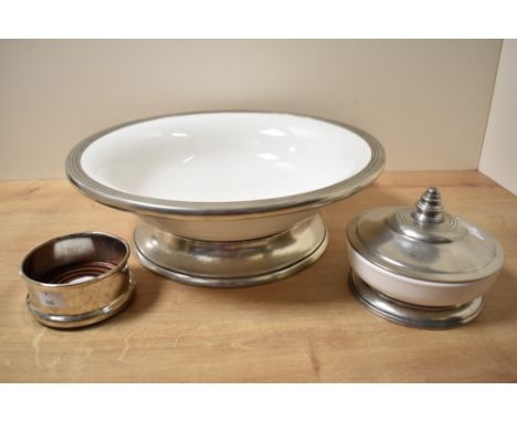 An Italian 'Arte Italica' metal mounted white ceramic bowl with circular foot, 37.5cm diameter, sold along with a smaller mat