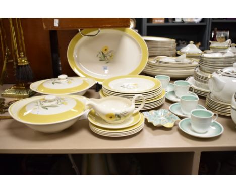 A Susie Cooper part dinner service, hand painted with floral designs and yellow border, comprising of two lidded tureens, sau