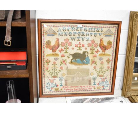 An attractive 19th century framed needlework pictorial alphabet sampler, depicting the alphabet, two roosters, a dog, house a