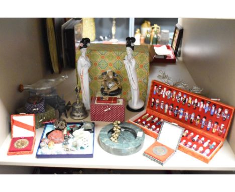 A collection of Chinese figures, to include a pair of ceramic madams, a Wah Jiang figurine, a glass dragon and a brass bell e