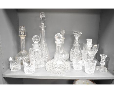 A group of cut crystal decanters, largest h43.5cm, sold together with 4 tumblers, 2 wine glasses and a candlestick, (14)