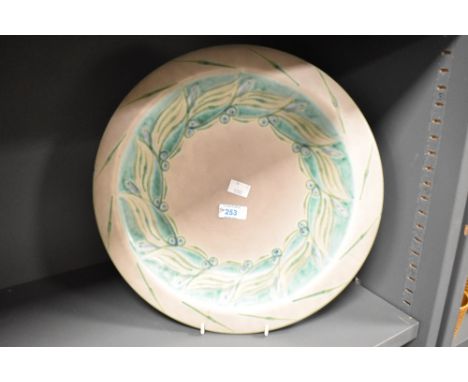 An early 20th century Royal Lancastrian lapis ware bowl painted with green motifs on a grey ground, impressed makers marks to