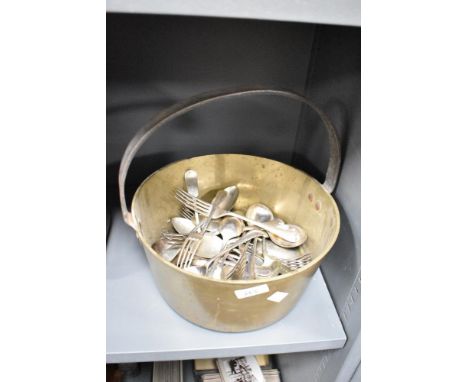 A brass jam pan containing a large quantity of silver plated spoons and forks, approximately 41 pieces
