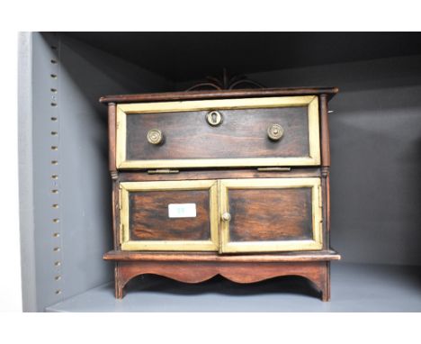 An interesting reproduction 'apprentice piece' or miniature secretaire, having a raised and scrolled back over the moulded re