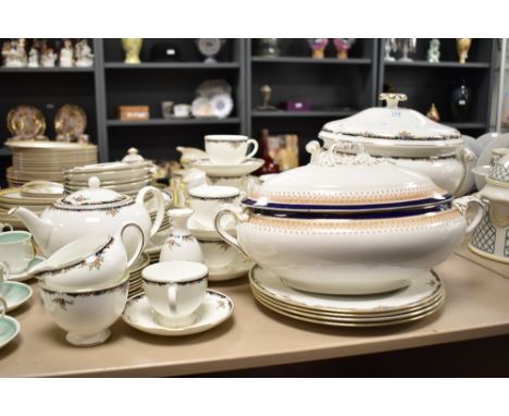 A Wedgwood Osborne pattern dinner service decorated with gilt edging and floral border, to include a lidded tureen, tea pot, 