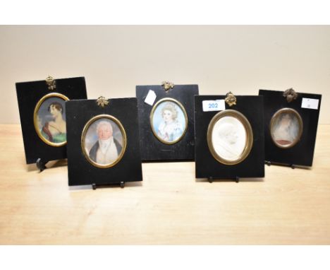 A 19th century miniature of a gentleman held under glass within a black lacquered frame, h13cm, sold together with various ot