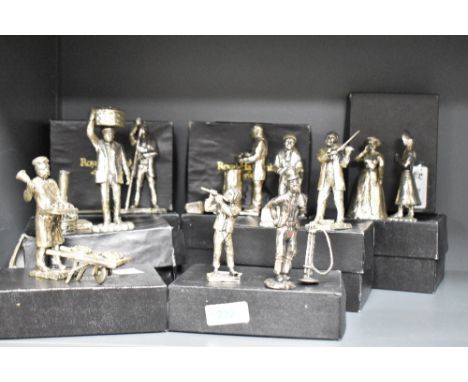 A group of Royal Hampshire Art Foundry silver plated figures and figurines including a flute player, a whittler and a shoe sh