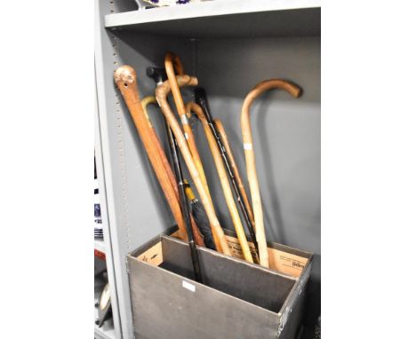 An adjustable fold away metal walking stick, h86cm, sold together with 8 wooden canes and an umbrella, (10)
