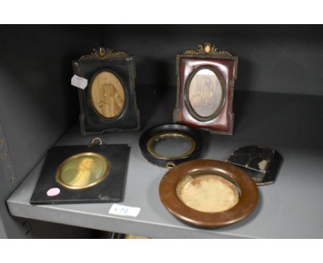 A 19th century miniature portrait of a gentleman mounted behind a gilt oval surround borded within a wooden frame, h13cm, sol
