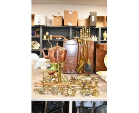 An early 20th century brass fireside tool set, h50cm, sold together with a copper kettle, a pair of brass candlesticks, a can