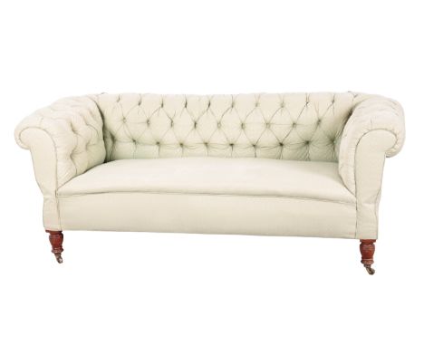 A VICTORIAN MAHOGANY CHESTERFIELD SOFA with green cotton button-back covers, both of the arms are adjustable and the sofa bec