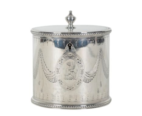 A GEORGE III SILVER CYLINDRICAL TEA CADDY probably by John Deacon, London 1776, engraved with swags and a griffin crest in an