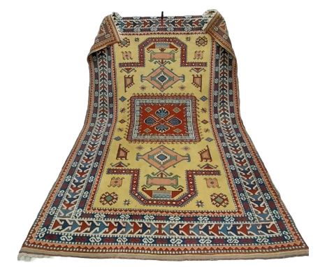 A large hand woven pure wool Turkish Elmaz carpet having all-over geometric patterns in iron red, midnight blue and dusty pin