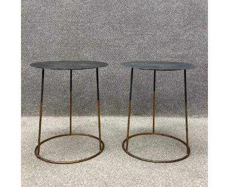 A pair of contemporary side or lamp tables each having a circular sheet metal top raised on a circular gilt metal tubular sub