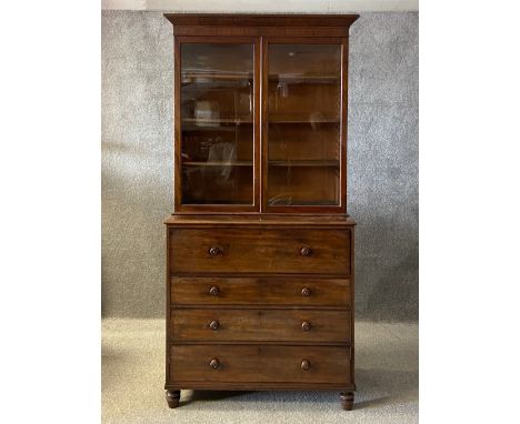 A Victorian mahogany library secretaire bookcase having a moulded cornice with a crossbanded frieze over two glazed cabinet d