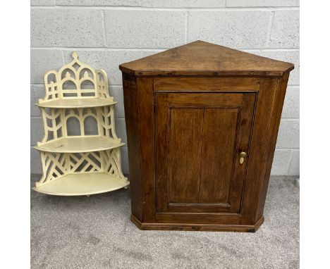A 19th century wall mounted oak corner cabinet having a panelled door with canted sides on a moulded plinth base. H.98.5 W.78