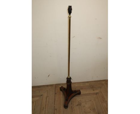 Regency rosewood pole screen, the brass column on scroll carved trefoil base with brass moulding and on three lobed brass fee