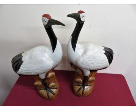 A pair of Japanese ceramic figures of cranes, with impressed signature panels to the base (H51cm) 