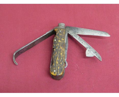 Late 19th C 'Game Keepers' pocket knife with 13 tools and 16 functions and twin antler grips. An inset, shield shaped cartouc