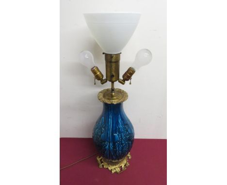 Large relief moulded baluster blue glazed three light table lamp, gilt metal top cast with grape vine, on openwork leaf cast 