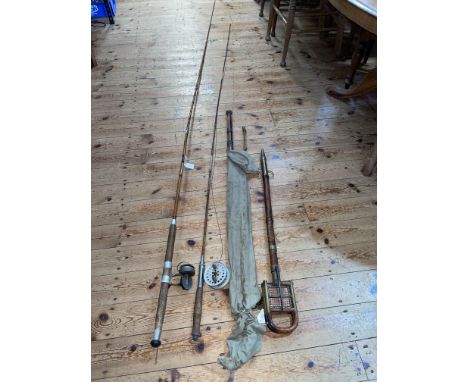 Vintage bamboo shooting stick and four vintage fishing rods.