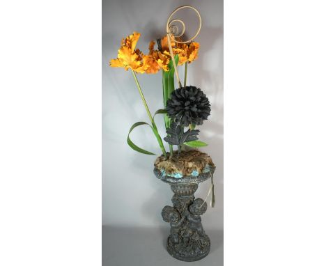 A Resin Figural Planter with Artificial Flowers, Planter 40cm high 