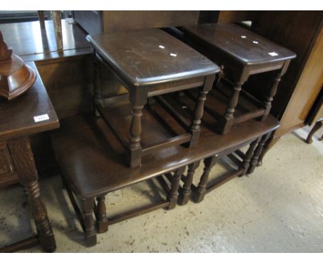 Ercol style elm nest of three rectangular tables, together with another Ercol style elm side tables or stools. (B.P. 24% incl