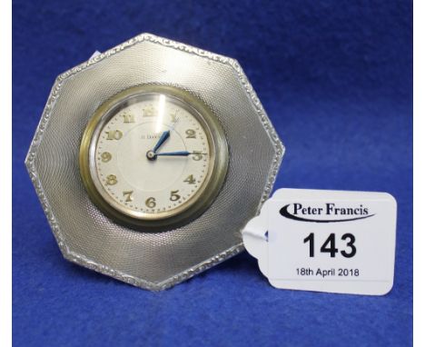 Small engine turned silver framed travelling clock with brass back winding movement. 8cm diameter. (B.P. 24% incl. VAT)