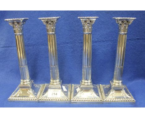 Good set of four loaded silver corinthian column candle sticks with gadroon removable sconces and gadrooned and foliate decor