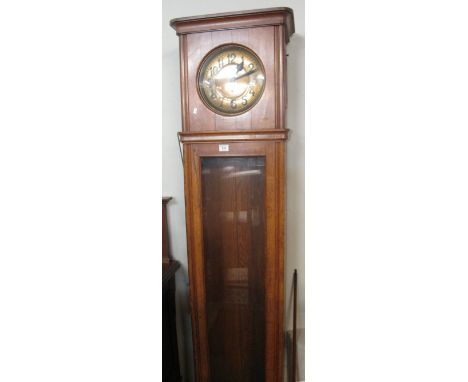 1920s oak two train long case clock with brass Arabic face and full length glazed door, on bracket base.(B.P. 24% incl. VAT)