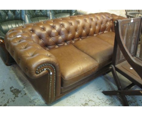 Good quality modern tan leather Chesterfield style three seater sofa with metal stud work decoration. (B.P. 24% incl. VAT)