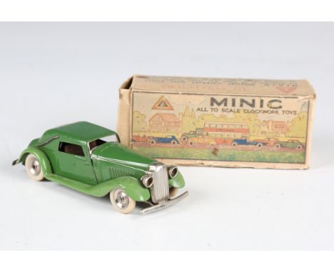 Three Tri-ang Minic toys, comprising pre-war Vauxhall, finished in duo-green with petrol can, boxed with key, caravan and No.