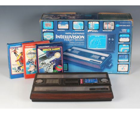 A Mattel Electronics Intellivision games console and fourteen games, including Space Spartans, Star Strike and Auto-Racing, a