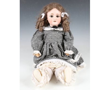 A German bisque head doll, impressed 'Special', with later brown wig, sleeping brown eyes, open mouth showing upper teeth and