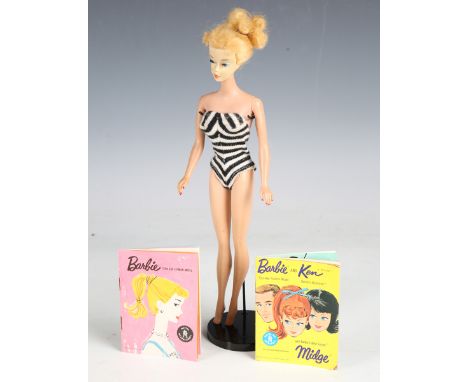 A 1960s Barbie doll fashion model set, the doll with blonde hair, wearing a black and white one-piece jersey swimsuit, sungla