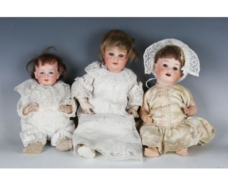 An Eisenmann &amp; Co Einco bisque head character doll, impressed '6/0', with brown wig, fixed blue eyes, painted features an
