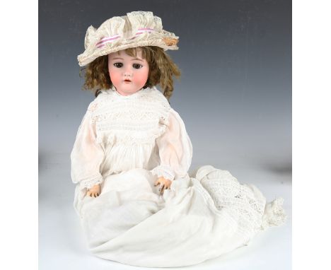 A Kammer &amp; Reinhardt bisque head, impressed '66', with brown wig, pierced ears, sleeping brown eyes, open mouth showing u
