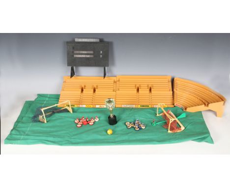 A collection of Subbuteo, comprising twelve teams, spare players, stadium scoreboard, terraces, goals, pitch and C119 World C