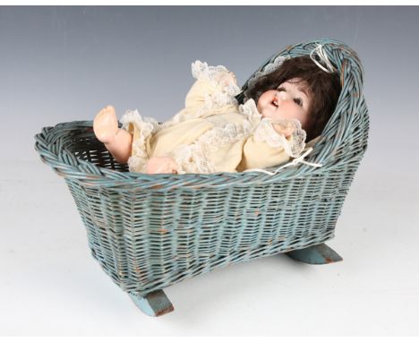 An Armand Marseille bisque head doll, impressed '995 A4M', with later brown wig, sleeping brown eyes, open mouth showing uppe