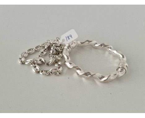 A silver hinged bangle and two bracelets