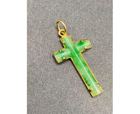 A very fine antique jade cross the good colour mottled green jade set in high carat gold
