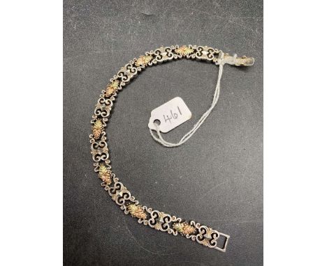 A gold on silver fancy link bracelet