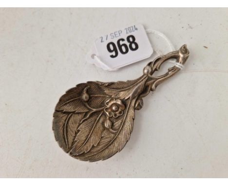 A cast electro plated caddy spoon with Art Nouveau motifs